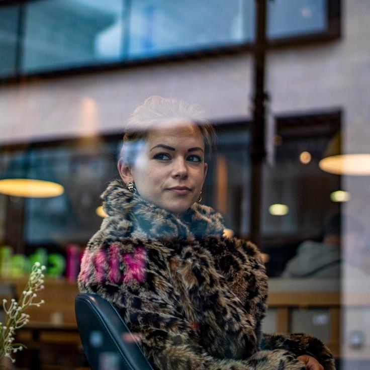 Alex Kim, Lead Design Curator at AnchorPaperGrove, reviewing corporate floral arrangements